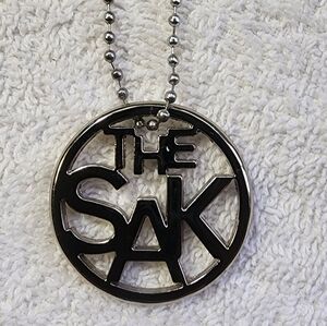 "The SAK " Silver Tone Metal  Bag Charm on ball chain. EUC